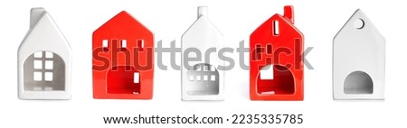 Collection of creative candle holders in shape of house on white background