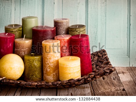 collection of decorative candles on a rustic antique wooden background