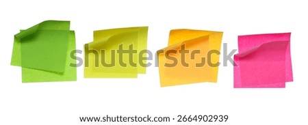 Collection of different colored sheets of note papers with curled corner, isolated on white background, clipping path