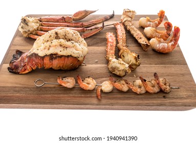 A Collection Of Different Kinds Of Seafood With Lobster Tail That Is Saddleback, Tiger Shrimp, Shrimp On Skewers, Alaskan Snow Crab And Alaskan King Crab