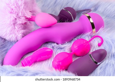 Collection Of Different Types Pink And Violet Of Sex Toys On Violet Background.Sex Toy For Adult, Dildo Vibrator,pink Vaginal Balls,clitoral Stimulator.