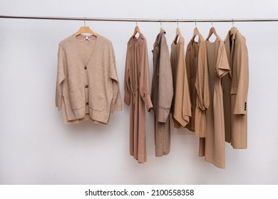 Collection Of ,dress Sweatshirt ,sweater And Jacket ,suit,coat  Hanging On Wooden Clothes Hanger In Closet Or Clothing Rack Over White Background