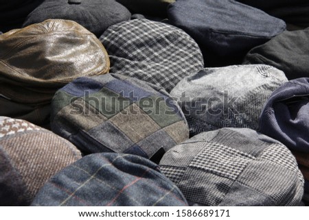 Collection of flat caps on display at a steam rally
