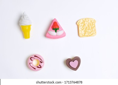 Collection Of Food Toys For Kids. Ice Cream, Slice Of Cake, Donuts. Flay Lay Image. White Background