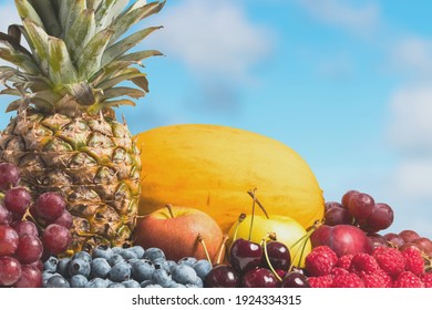 Collection of fresh fruit outside with the sky in the background