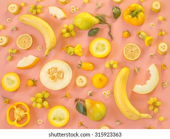 Collection of fresh yellow fruit and vegetables on the light pink background