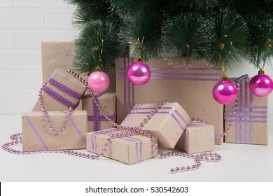 Collection Of Gifts Under A Christmas Tree Decorated With Toys