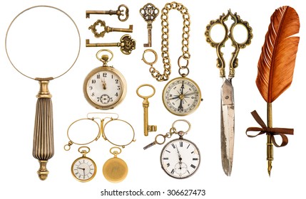 Collection of golden vintage accessories and antique objects. Old keys, clock, loupe, compass, ink feather pen, scissors, glasses isolated on white background