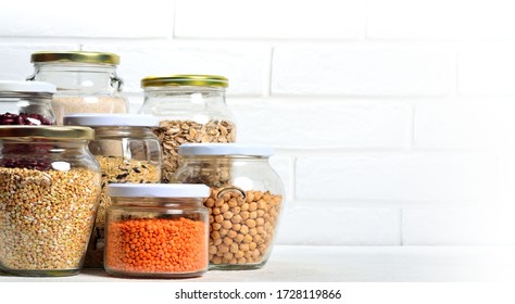 Collection of grain products in storage jars in pantry. Copyspace background. - Powered by Shutterstock