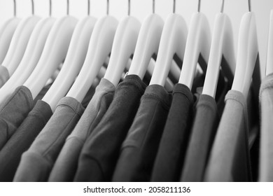 Collection of gray color t-shirts hanging on clothes hanger