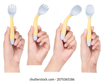 Collection Of Hand Holding Bendable Kids Training Spoon Fork Set Isolated On White Background.