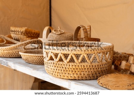 A collection of handcrafted tableware made from inner bark, including wide drying baskets, plates, and serving trays