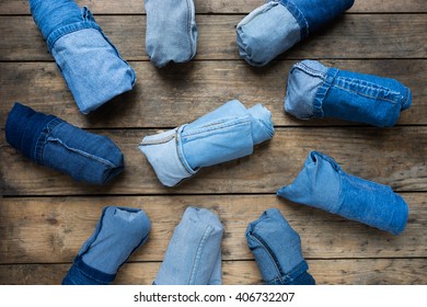 Collection jeans rolled on a wooden background - Powered by Shutterstock