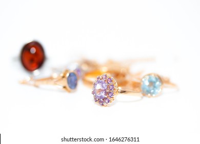 Collection of jewelry with beautiful golden ring with purple stone isolated on white background