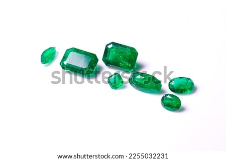 A collection of loose Emerald gemstones. Single stones for jewellery. Isolated on a white background