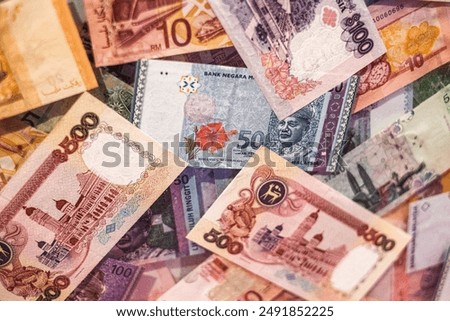 A collection of Malaysian Ringgit banknotes in various denominations