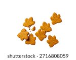 A collection of maple leaf shaped ginger cookies are scattered across a clean white background. One cookie is broken, revealing its crumbly interior. The...