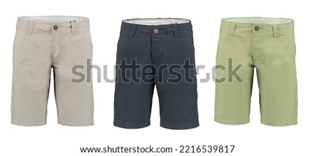 Collection of men's Bermuda shorts on a white background. Isolated image on a green background. Nobody. 