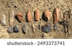 A collection of Middle Stone Age and Late Stone Age tools, and a piece of historical wire from an archaeological site in South in Africa.