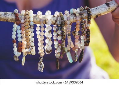 Collection of mineral stone beaded bracelets on natural outdoor background