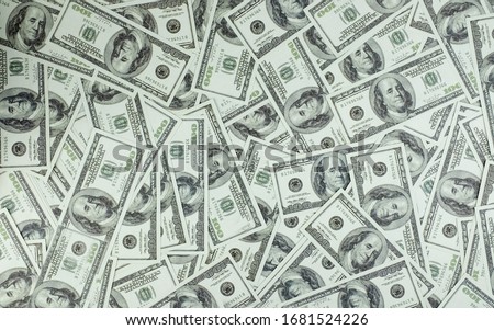 It is a collection of money stacks of 100 US dollar banknotes that make up a large portion of the background, top view