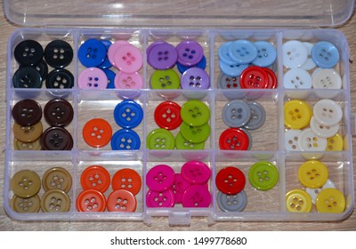 Collection of multicolor plastic buttons for sewing and handcraft sorted in a plastic box on wooden background. Components of various colors for sewing, scrapbooking and other diy activities. - Shutterstock ID 1499778680