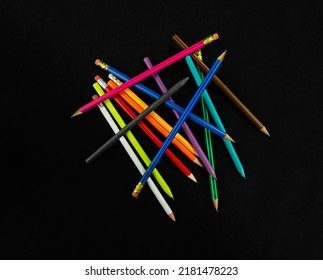 Collection of multicoloured pencils on a black background,  no visable trademarks