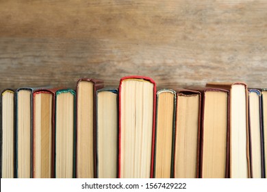 Collection of old books on wooden background - Shutterstock ID 1567429222
