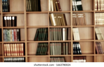 Collection of old books on a wooden shelf