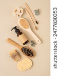 A collection of personal care items including a bamboo toothbrush, soap bar, clean brush, reusable bottle. Zero waste sustainable lifestyle concept. Eco friendly wellness and self care.