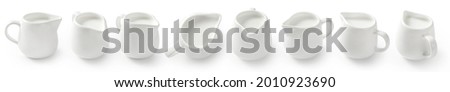 Collection of porcelain milk jars isolated on white background. Milk pitchers for package design. Top view of milk. Porcelain creamer pitcher with milk on white.