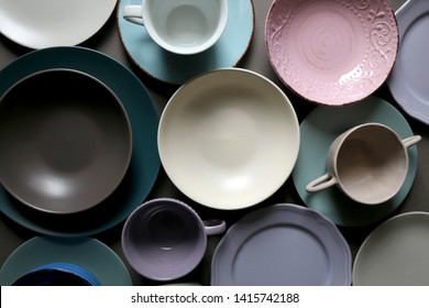 Collection of pottery and kitchenware in muted pastel colors. Top view.
