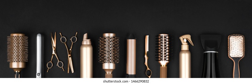 Collection of professional hair dresser tools arranged on dark background