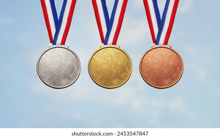 Collection of real gold medals isolated on blue sky background with a lot of text area - winner copy space concept - Powered by Shutterstock