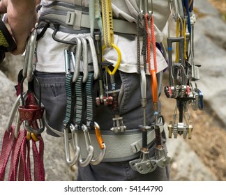 Collection of rock climbing gear attached to a climber's harness