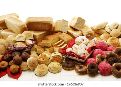 A collection of savory and sweet baked goods on an isolated white background