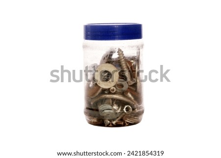 Collection of screws and hardware in plastic jar. Isolated on white. Room for text. Clipping Path. Nuts, bolts and other parts other in plastic jar with a plastic lid. spare parts. washers. nails.