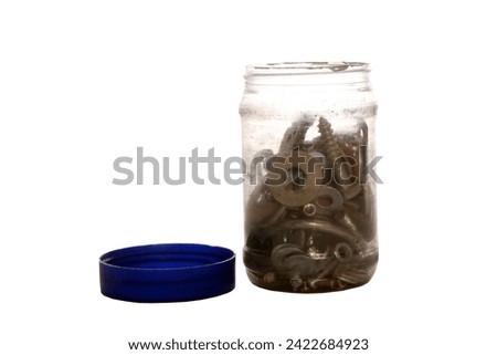 Collection of screws and hardware in plastic jar. Isolated on white. Room for text. Clipping Path. Nuts, bolts and other parts other in plastic jar with a plastic lid. spare parts. washers. nails.