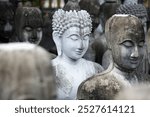 A collection of serene Buddha statues captured in a monochrome scene, showcasing intricate artistry and spiritual tranquility in a peaceful outdoor setting.