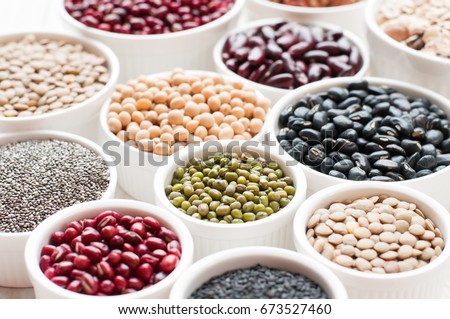collection set of beans, legumes, peas, lentils on ceramic bowl on white wooden background