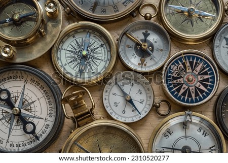 Collection, set of old compasses on the table. Travel, geography, navigation, tourism, histoory and exploration concept background. Old compass background.