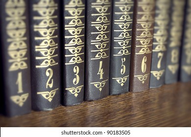 Collection of several volumes of books on a wooden shelf - Powered by Shutterstock