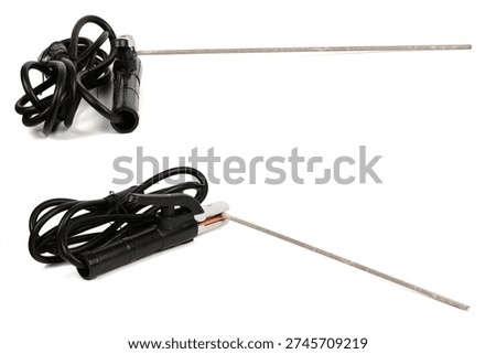 Collection showing two angles of a welding electrode holder with a welding rod and coiled cable. Industrial arc welding equipment isolated on white.