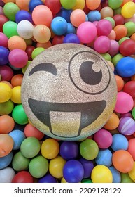 A Collection Of Small Colorful Plastic Balls With Emoticon Big Ball