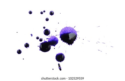 Collection of small and large blue dried ink spots or inkblots on white paper