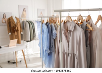 Collection of stylish women's clothes in modern boutique. Space for text