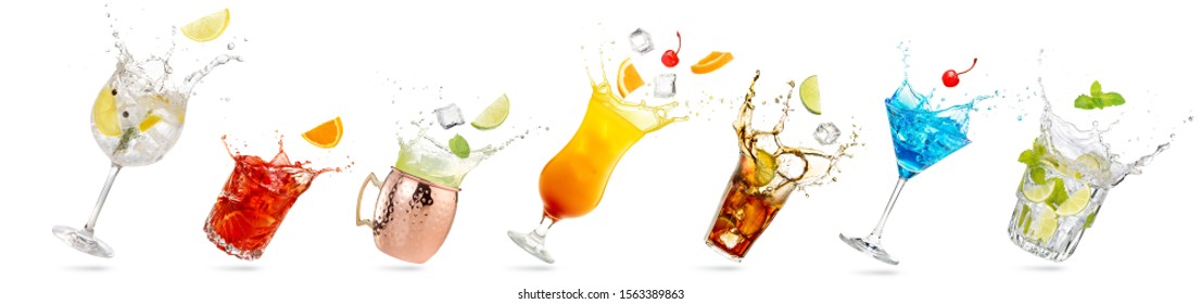 collection of tilted glasses with splashing cocktails isolated on white