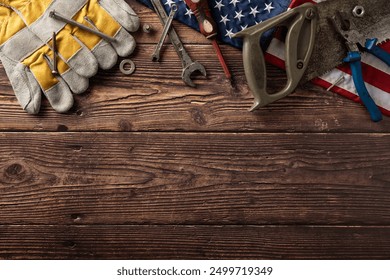 A collection of tools on a rustic wooden background with an American flag. Concept for Labor Day in the USA - Powered by Shutterstock