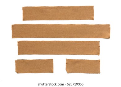 Collection Of Torn Physio Tape Strips Isolated On White.  Brown Fabric, For Therapeutic Strapping.