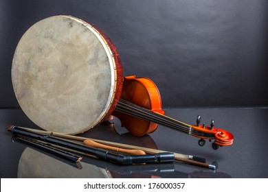 A collection of traditional Irish musical instruments on a black background
